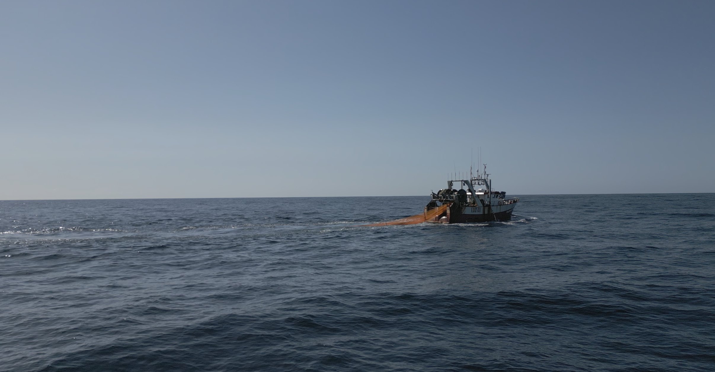 A fishing vessel underway, seen from above.